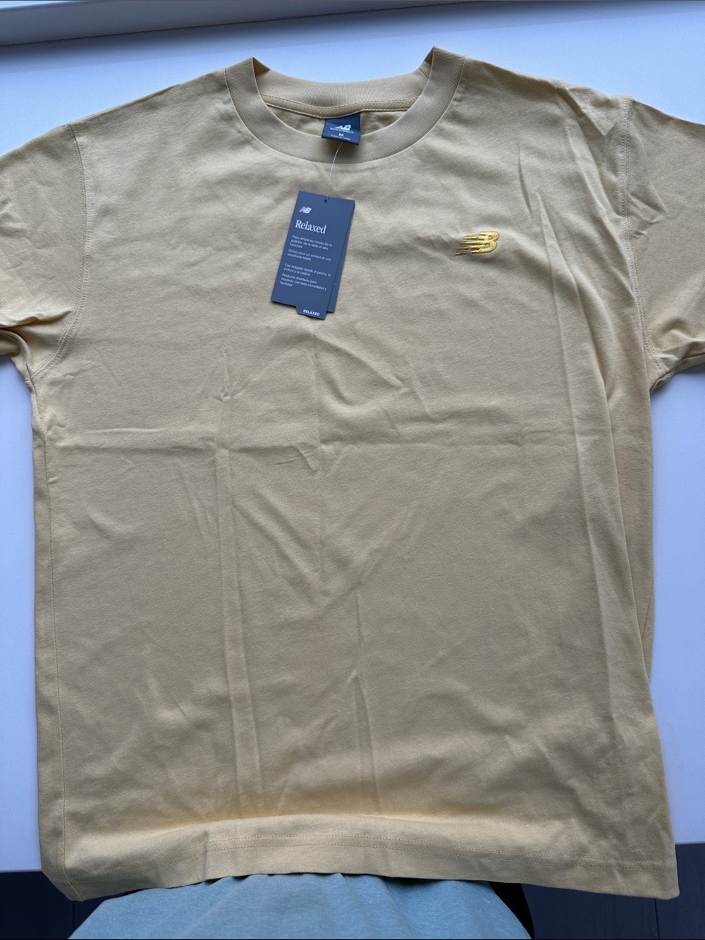 New Balance Men’s Relaxed Crew T-Shirt in Light Yellow with Gold Logo